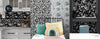 Black, white and shades of gray floral wallpaper panels shown in a bedroom, kitchen backsplash and corner area. 