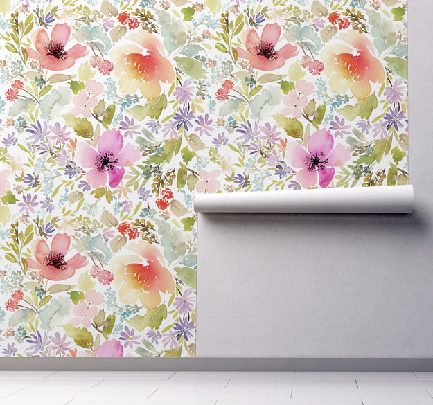 Soft and vibrant watercolor wallpaper Panel shown on wall rolling downwards. Very colorful orange, purples, pinks and greens dominate the flower pattern.